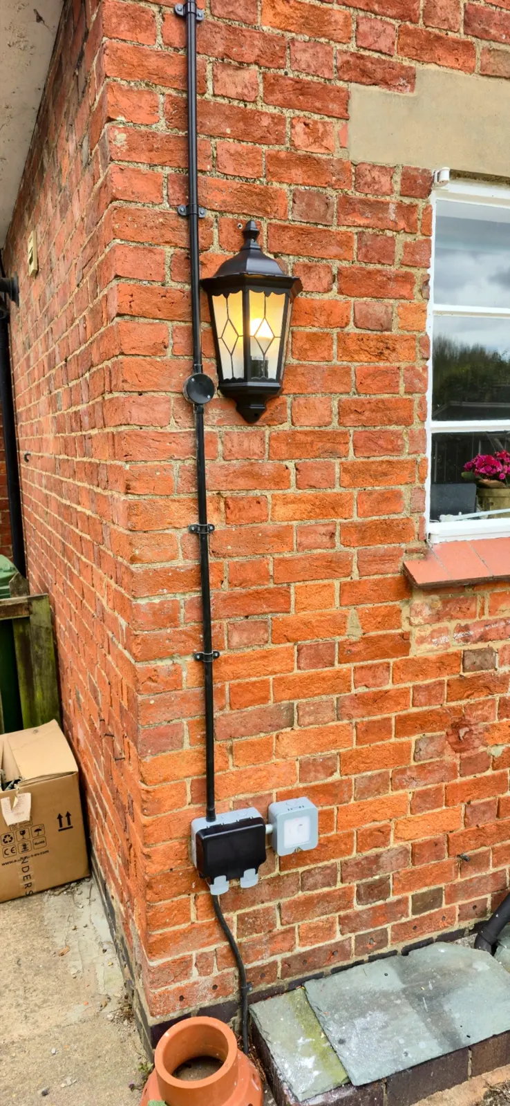 Outdoor electrical installation with conduit lighting and socket
