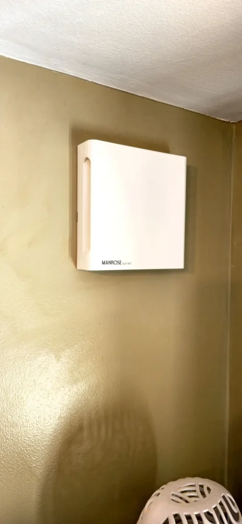 White Manrose Quiet extractor fan mounted high on an internal wall in Milton Keynes